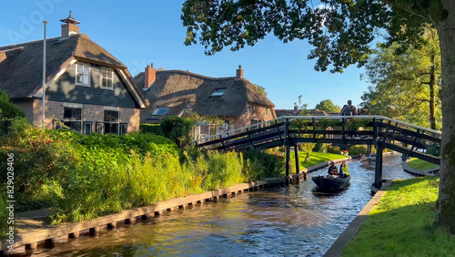 Traditional dutch houses, gardens and water canals and wooden bridges in village is know as Venice of the North Giethoorn, Netherlands, Julay 30, 2023
