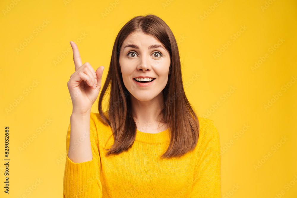 Excited beautiful middle aged woman holding finger up, having idea, looking at camera Excited beautiful middle aged woman holding finger up, having idea, looking at camera