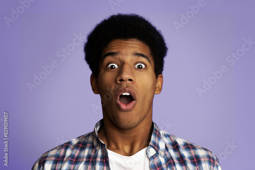 Surprised and Shocked Teenage Guy Opened Mouth in Amazement, Pink Studio Background