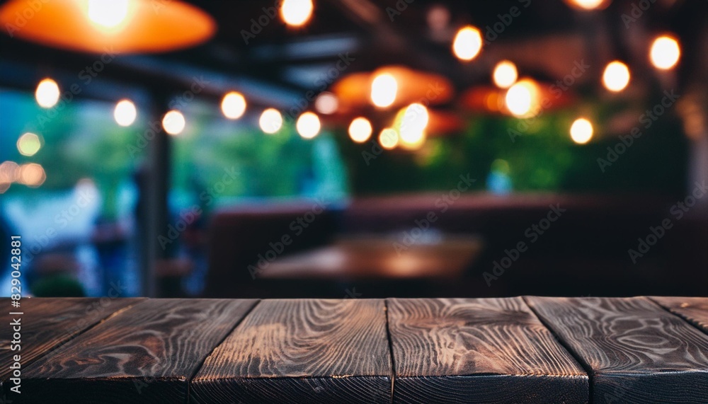 empty dark wood table in the cafe with a blurred background