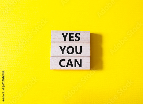 Yes You Can symbol. Concept word Yes You Can on wooden blocks. Beautiful yellow background. Business and Yes You Can concept. Copy space.