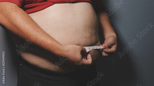 Overweight man's belly,fat man has excess fat, he is dieting and losing weight.unhealthy,medical health concept with copy space space for text photo