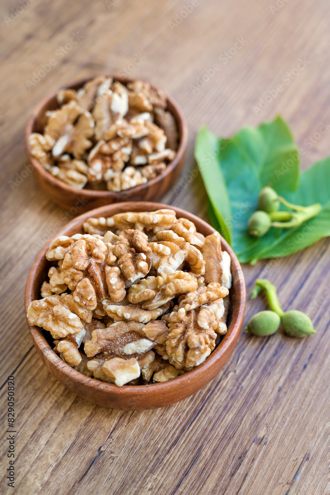 Raw Walnuts in a wooden bowl Raw Walnuts in a wooden bowl