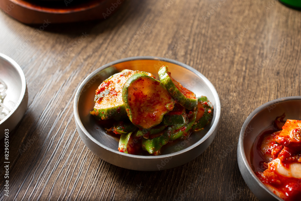 A view of a side of Korean banchan spicy marinated cucumbers, known as oi muchim. A view of a side of Korean banchan spicy marinated cucumbers, known as oi muchim.