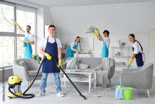 Team of young janitors clea...