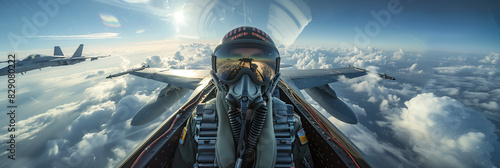A fighter pilot wearing a helmet in the cockpit is flying high above the clouds. photo