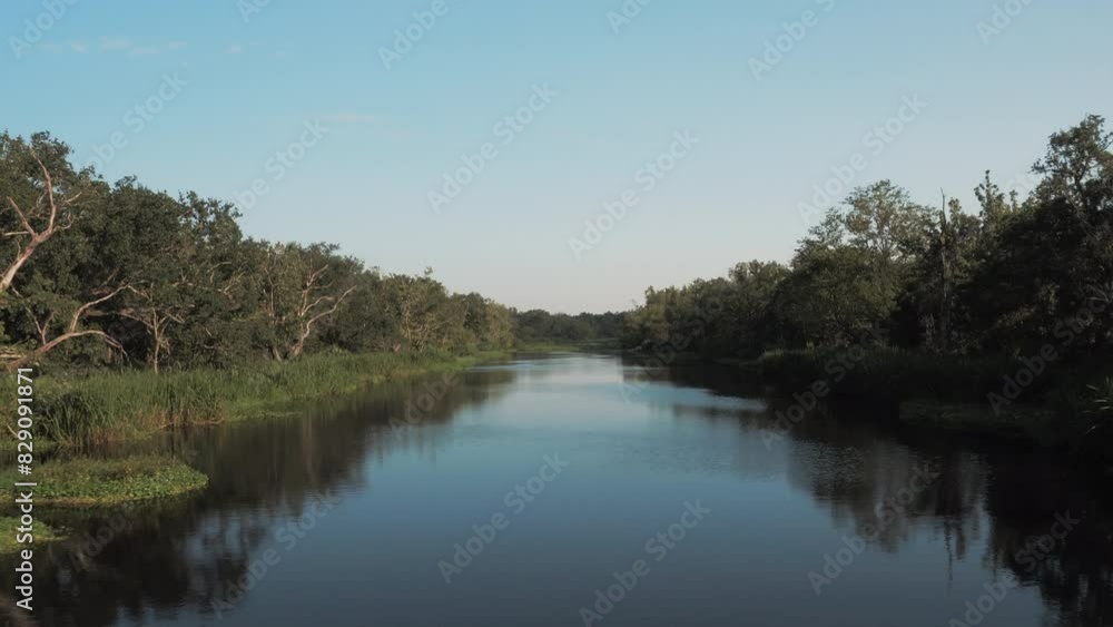 Aerial: Drone Forward Shot Of Rippled River Stream Amidst Green Plants Against Clear Sky On Sunny Day - Bayou Vista, Texas Aerial: Drone Forward Shot Of Rippled River Stream Amidst Green Plants Against Clear Sky On Sunny Day - Bayou Vista, Texas