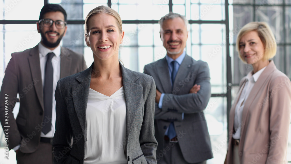 business woman with crossed arms against the background of a business team business woman with crossed arms against the background of a business team