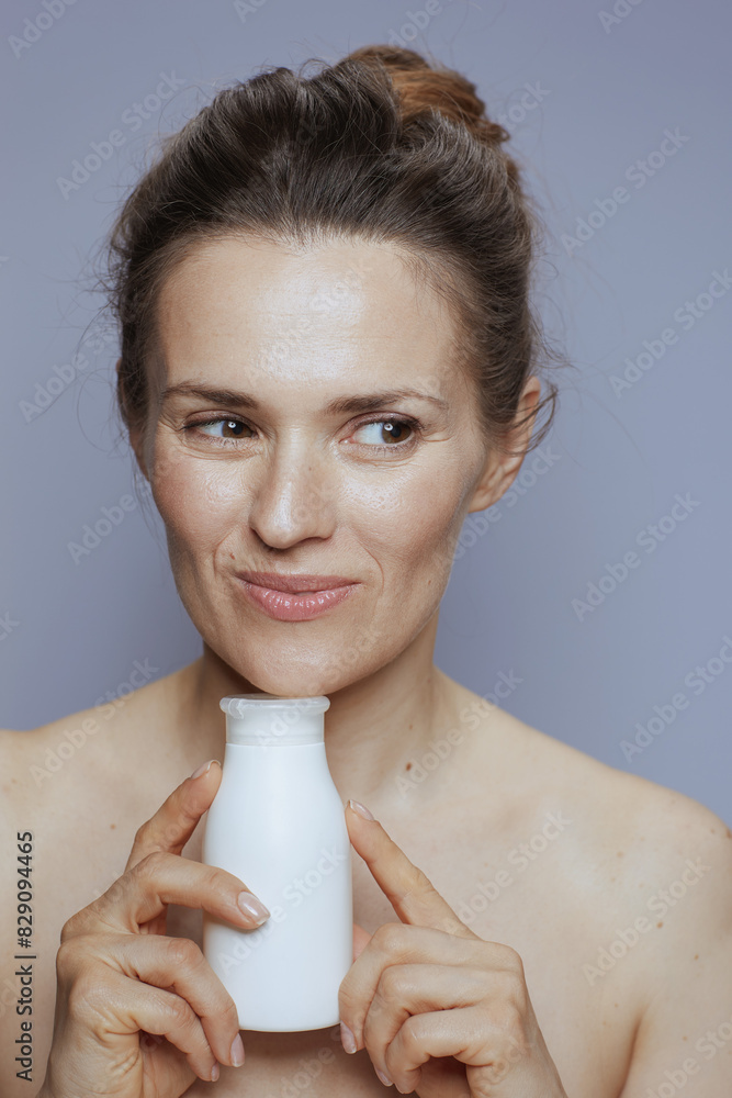pensive modern woman with cosmetic cream jar pensive modern woman with cosmetic cream jar
