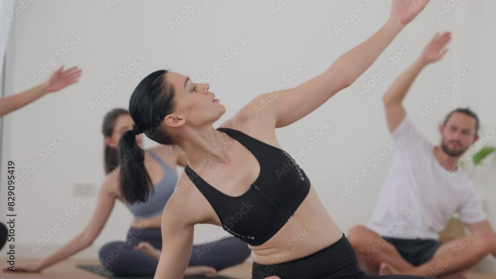 Group Yoga Class in a Bright Studio with Instructor Giving Guidance Group Yoga Class in a Bright Studio with Instructor Giving Guidance