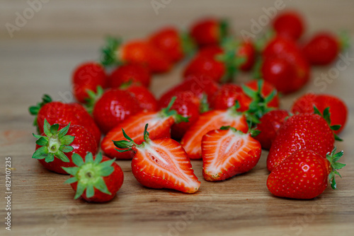 Fresh delicious selected strawberries on a brown wooden table