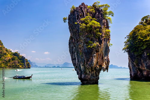Limestone karst and pinnacle in a tropical ocean in Thailand photo