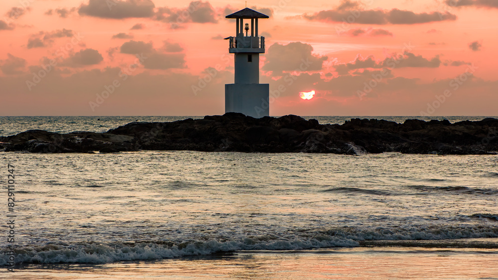 Tropical sunset behind a lighthouse on a warm ocean (Nangthong Beach, Khao Lak, Thailand) Tropical sunset behind a lighthouse on a warm ocean (Nangthong Beach, Khao Lak, Thailand)