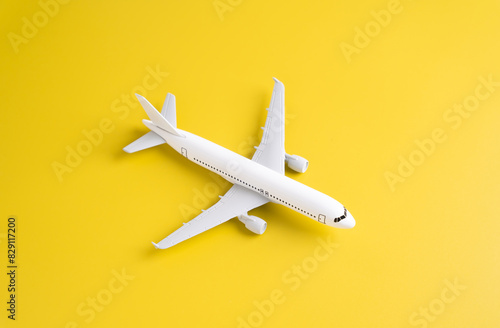 Wallpaper Mural Passenger plane on a yellow background. Airplane figurine. Commercial flights Torontodigital.ca