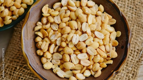 Bowl filled with roasted peanuts, highlighting their golden color and crunchy texture