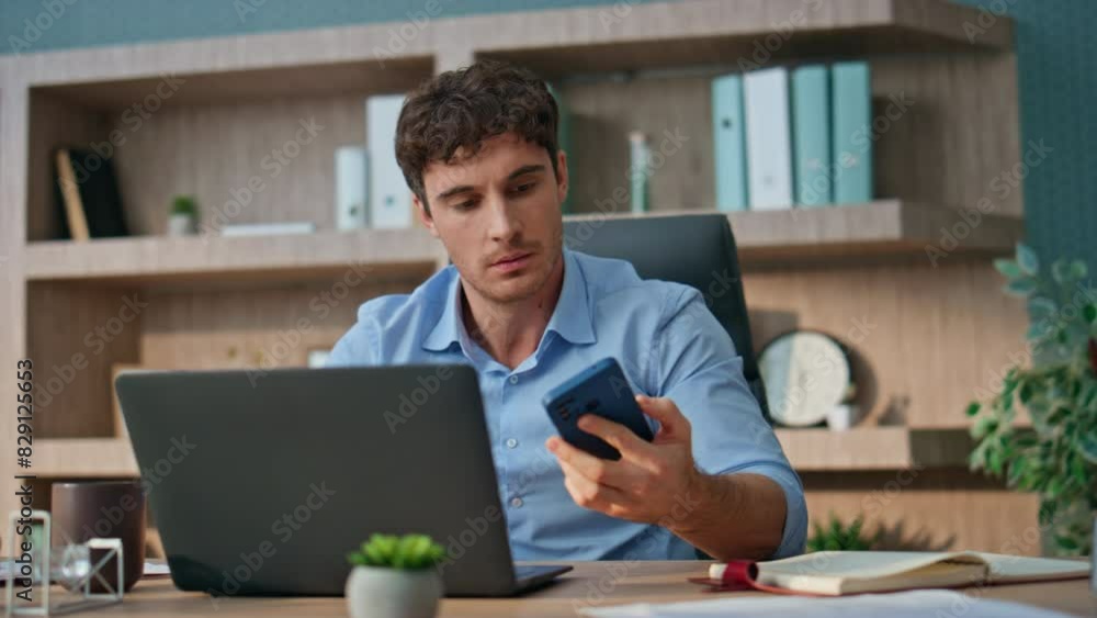 Business worker celebrating message in office. Happy man receiving good news Business worker celebrating message in office. Happy man receiving good news