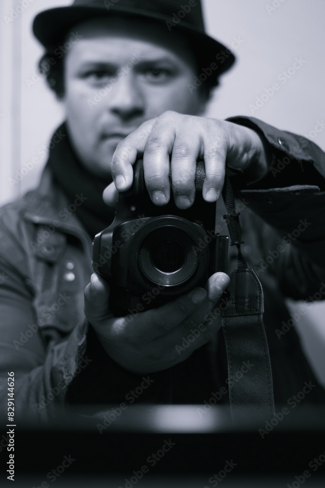 a man holding a camera in front of a mirror, black and white photography a man holding a camera in front of a mirror, black and white photography