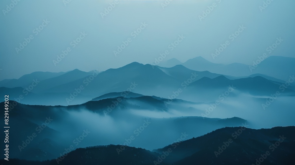 The mountains appearing faded and distant obscured by the thick fog.