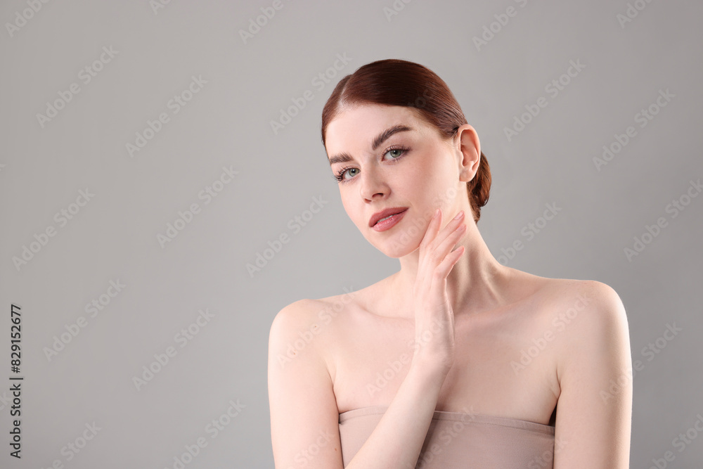 Portrait of beautiful woman on grey background. Space for text Portrait of beautiful woman on grey background. Space for text