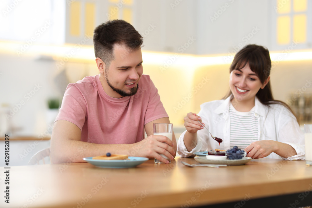 Happy couple having tasty breakfast at home Happy couple having tasty breakfast at home