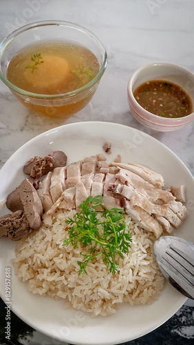 Hainanese Chicken Rice or Chicken Soup Rice - Asian Feet Style thaifood concept on white background. 