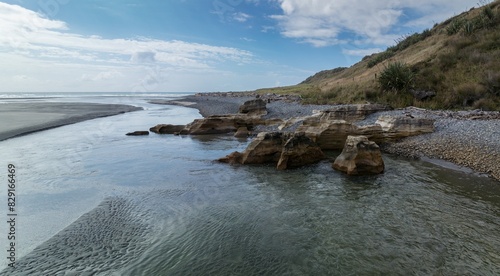 Rivermouth of the Paturau River flowing into the ocean. Mangarakau, Paturau, Tasman, New Zealand. photo