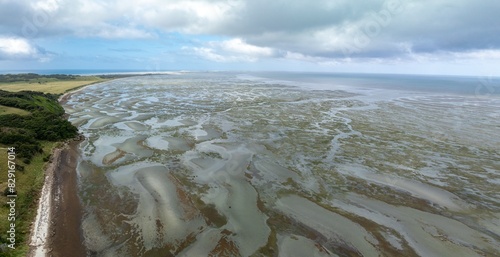 The Farewell Spit at the top of the South Island at low tide at sunset. Puponga, Collingwood, Tasman, New Zealand. photo