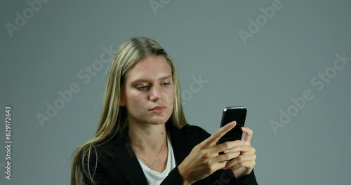 Frustrated woman despairs at smartphone, gestures wildly