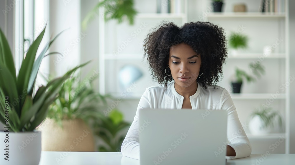 Woman useing laptop in bright modern studio office Woman useing laptop in bright modern studio office