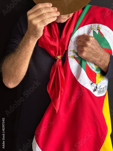 Gaucho with hat, red scarf and flag of the State of Rio Grande do Sul - Southern Brazil. photo