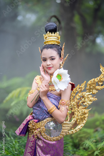 Cute girl in Kinnaree dress. The Kinnaree is significant character in Thai literature, a half-human, half-bird creature, a beautiful woman with wings to fly, resides in the Himavanta forest