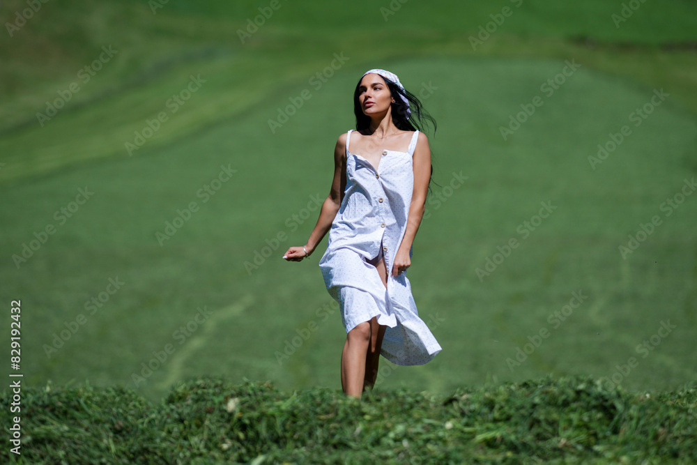 Woman on green field of the grass. A woman farmer on green grass in the field. Eco organic and agriculture concept. Harvesting and mowing grass. Cutting the grass. Woman on green field of the grass. A woman farmer on green grass in the field. Eco organic and agriculture concept. Harvesting and mowing grass. Cutting the grass.