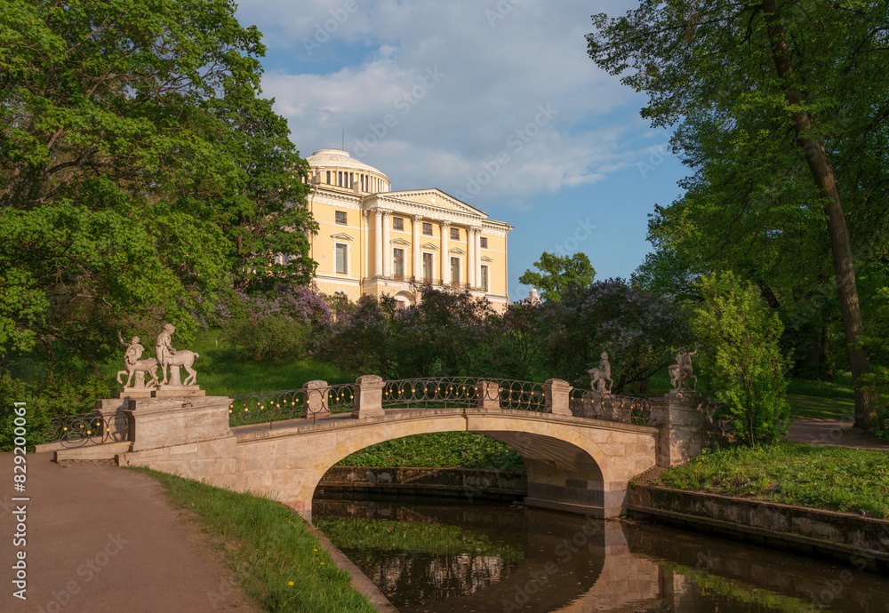 Fototapeta premium Centaur Bridge in Pavlovsky Park against the background of the Pavlovsky Palace on a sunny summer day, garden and park reserve in St. Petersburg, Russia
