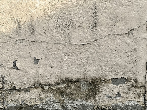 a photography of a wall with a cracky paint and a fire hydrant.