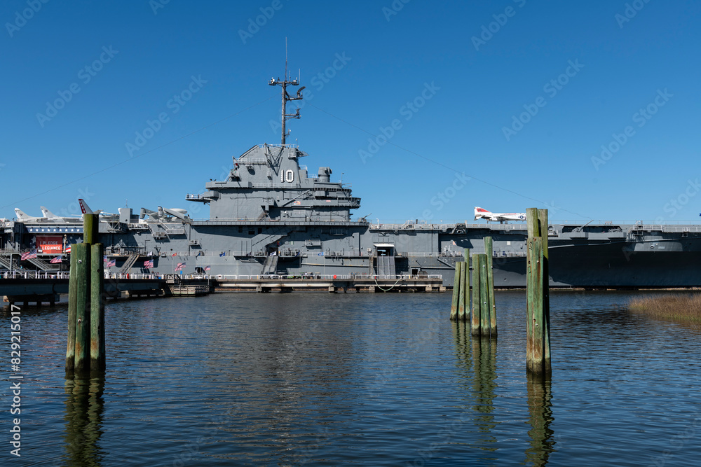 CHARLESTON, SC, USA - March 29, 2024: USS Yorktown in dry dock showing midship section with aircraft and people touring the deck. CHARLESTON, SC, USA - March 29, 2024: USS Yorktown in dry dock showing midship section with aircraft and people touring the deck.