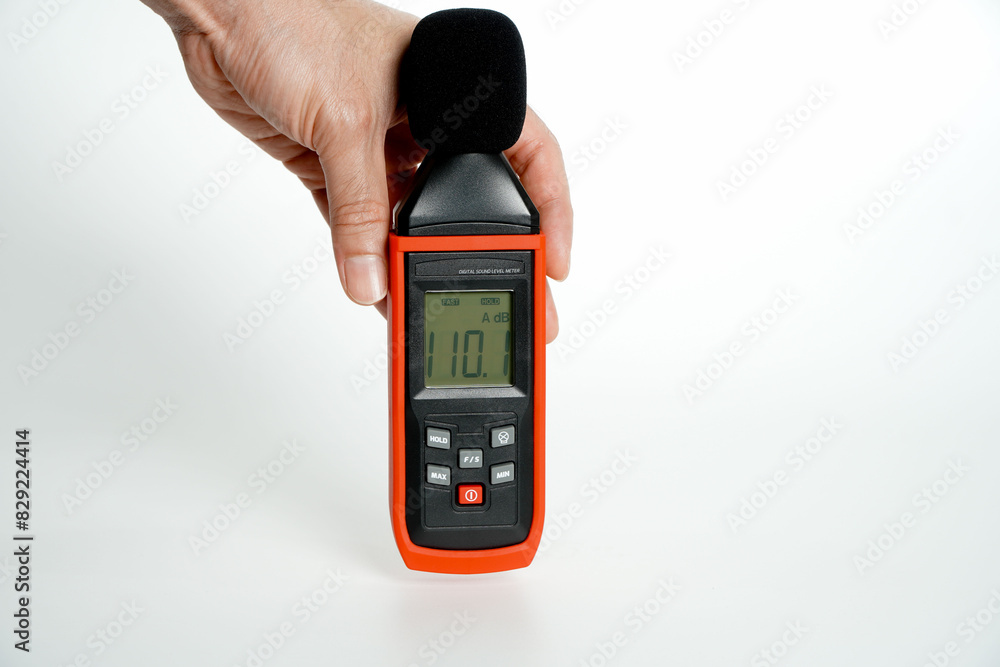 Pollution is too loud.hand holding a digital sound level on a white ...