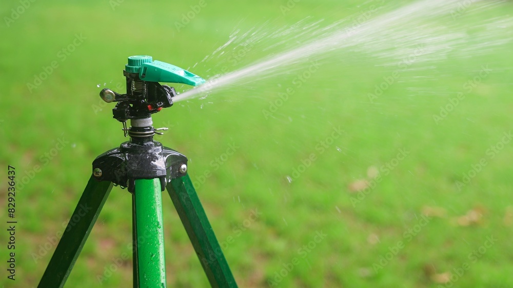 Yard Impact Pulse Sprinkler Watering Green Grass Lawn, water stream spray droplets Yard Impact Pulse Sprinkler Watering Green Grass Lawn, water stream spray droplets