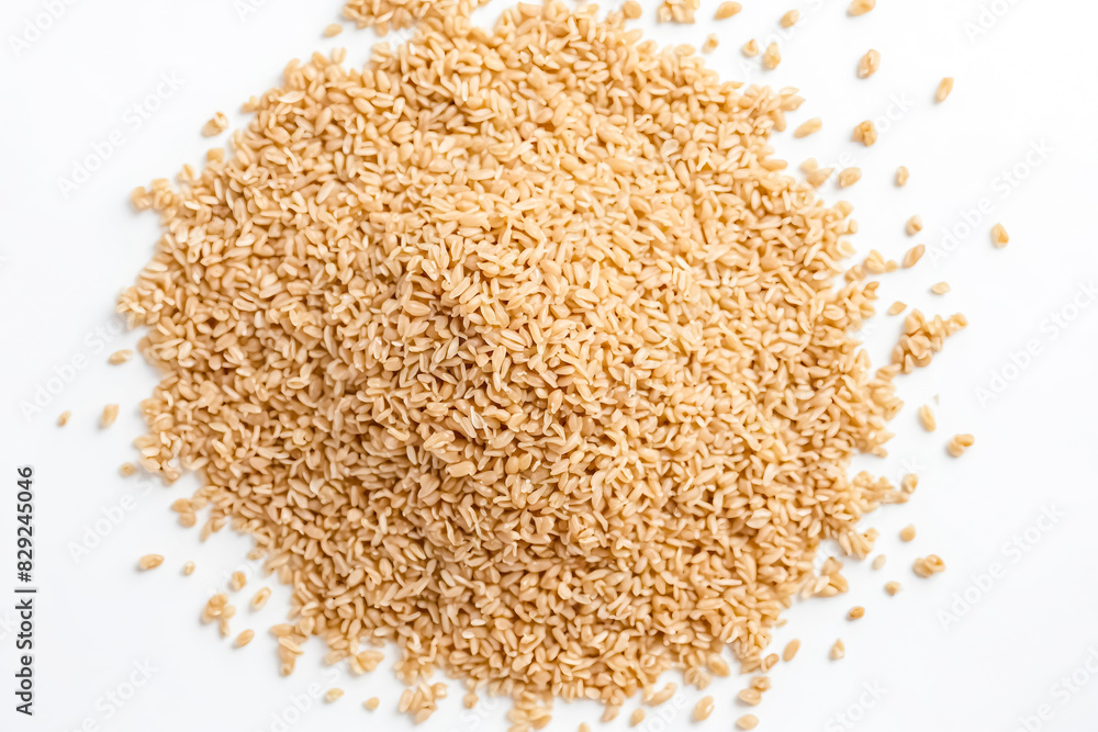 Uncooked Brown Rice Grains Scattered on White Surface Uncooked Brown Rice Grains Scattered on White Surface