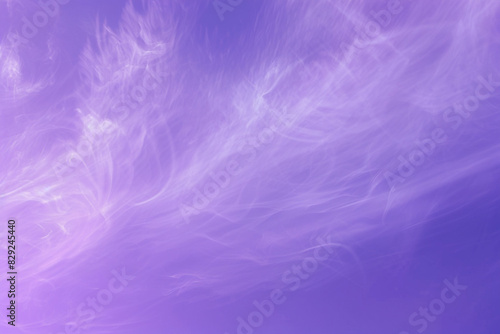 Peaceful atmosphere created by wispy clouds in an abstract violet backdrop.