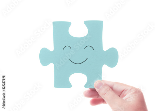 Piece of happiness. Hand holding a jigsaw puzzle. Mental health care. Fill with positive. Good solution mindset. Giving smile. Cooperation and support © Win Nondakowit