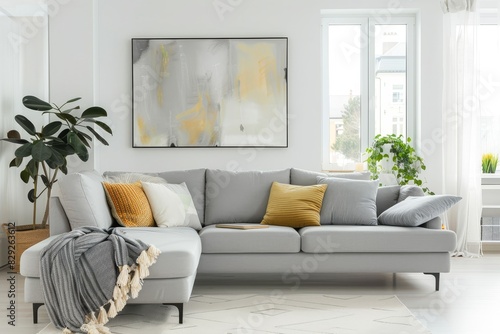 Grey sofa with blankets cushions plants big window and abstract painting in white living room