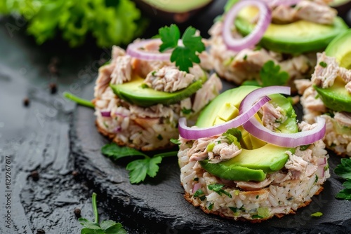 Nourishing snack rice cake with avocado and tuna salad