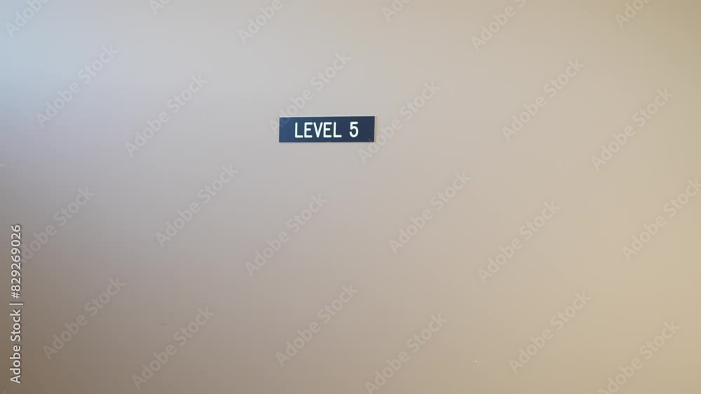 Level 5 sign on beige wall in a modern building interior Level 5 sign on beige wall in a modern building interior
