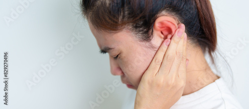 Woman holding her painful Ear. Ear disease, Atresia, Otitis Media, Inflation, Pertorated Eardrum, Meniere syndrome, otolaryngologist, Ageing Hearing Loss and Health concept photo