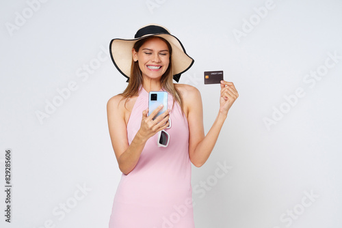 Happy asian woman using credit card and smartphone app, paying on website via mobile phone, white background.