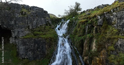 Waterfall and river on the hillside photo