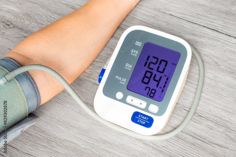 Man check blood pressure monitor and heart rate monitor with digital pressure gauge. Health care and Medical concept	