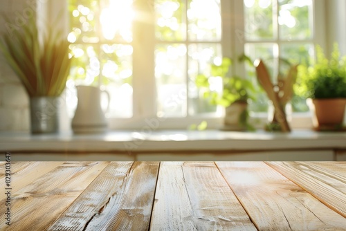 Wooden table top with bleached finish against blurred kitchen window in summer photo