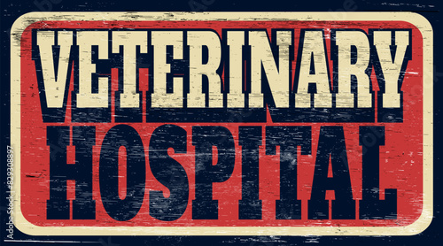 Aged and worn veterinary hospital sign on wood