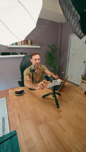 A content creator is using professional equipment to record videos for an online platform photo